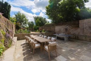 a wooden table and chairs on a patio at Ludlow Townhouse in Ludlow