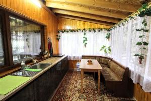 a kitchen with a couch and a table and a sink at Гостинний комплекс "У Валентини" in Yablunytsya