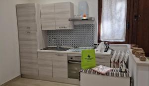 a kitchen with a sink and a stove top oven at Il Giardino Nascosto in Ascea +6 photos