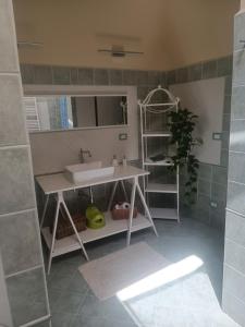 a bathroom with a sink and a mirror at appartamento vale in Viareggio