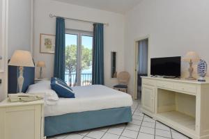 Postel nebo postele na pokoji v ubytování Hotel Garden Riviera