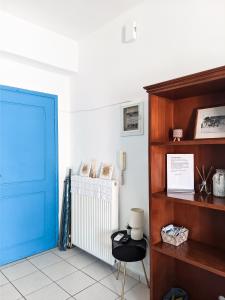 a room with a blue door and a chair at Beautiful apartment in Chania in Chania