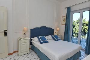Postel nebo postele na pokoji v ubytování Hotel Garden Riviera