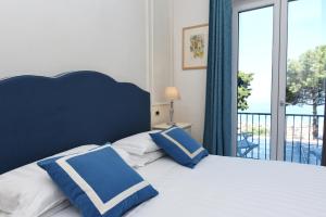 Postel nebo postele na pokoji v ubytování Hotel Garden Riviera