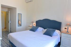 Postel nebo postele na pokoji v ubytování Hotel Garden Riviera