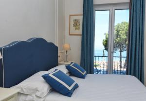 Postel nebo postele na pokoji v ubytování Hotel Garden Riviera