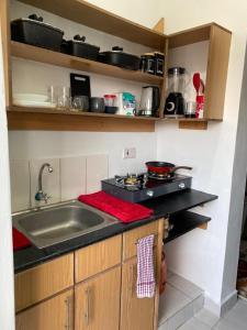 a kitchen with a sink and a counter top at Rio-vista Apartments in Nairobi