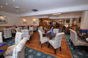 a restaurant with tables and chairs in a room at The Seacourt in Bridlington