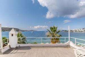 a view of the ocean from the balcony of a house at Seafront Rooms Bitez in Bodrum City