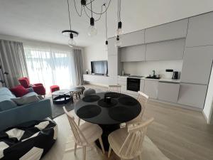 a kitchen and a living room with a table and chairs at Kasperky 14 in Kašperské Hory