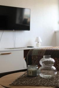 a glass jar on a table in a living room at Blue Apartment in Bihać