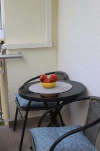 a small table with a bowl of fruit on it at Blue Apartment in Bihać