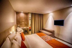 Postel nebo postele na pokoji v ubytování Hotel Citrus Prime Candolm, Goa