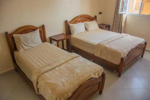 Uma cama ou camas num quarto em Hôtel Afoulki Tiznit