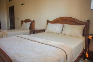 Uma cama ou camas num quarto em Hôtel Afoulki Tiznit
