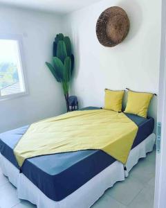 a bedroom with a bed with a yellow and blue blanket at Kazandko : Location meublée Haute-Savoie in Arenthon