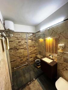 uma casa de banho com um chuveiro e um lavatório. em hotel babu heritage em Bikaner