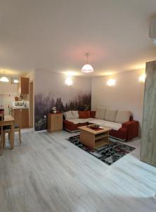 a living room with a couch and a table at Enigma Apartmani Divcibare in Divčibare