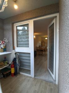 a sliding glass door leading to a dining room at Enigma Apartmani Divcibare in Divčibare