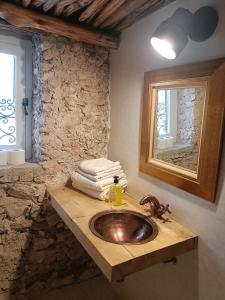 a bathroom with a wooden sink and a mirror at Country house Mogador in Essaouira