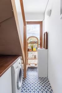 a laundry room with a washer and dryer in a house at Seafront Rooms Bitez in Bodrum City