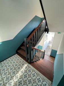 a hallway with a staircase with wood and tile floors at STUDIO IBIZA - HYPER CENTRE LORIENT in Lorient
