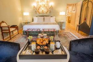 a hotel room with a bed and a tray of food at Corte Realdi - Palazzo Camozzini in Verona