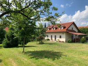 a house with a tree in the yard at Villa Lypche in Bešeňová