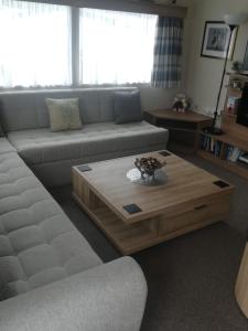a living room with a couch and a coffee table at Del's den lakeside weeley bridge 2bedroom in Weeley
