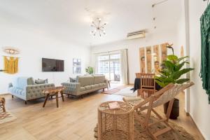 a living room with a couch and a chair at Seaview Rooftop in San Stefano in Alexandria