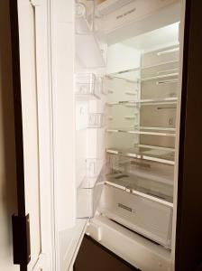 an empty refrigerator with its door open at Apartament Home Mi in Nysa