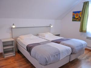 a bedroom with two beds and a window at Beautiful Holiday Home in Barvaux-sur-Ourthe with Sauna in Barvaux