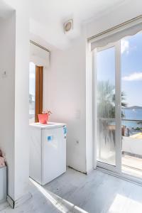 a white kitchen with a view of the ocean at Seafront Rooms Bitez in Bodrum City