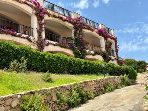 a building with flowers on the side of it at Only One Piccolo Pevero in Arzachena