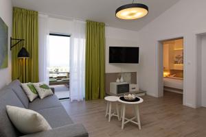 a living room with a couch and a table at Holiday Homes Oliva in Bol