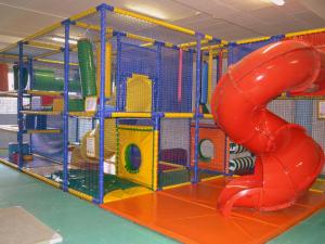 a play structure with a red slide in a room at Villa in France with Private Pool in Vasles