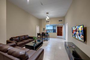 a living room with a couch and a table at City Stay Residences - Serviced Apartments DIP in Dubai