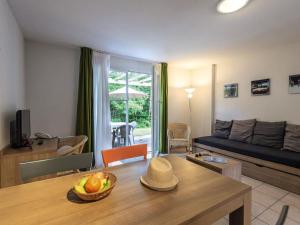 a living room with a couch and a table at Beautiful maisonnette with included linen package in Saumur in Saumur