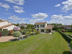 a house with a large yard with a grass yard at Luxury Villa in France with Pool in Vasles