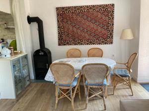 a dining room with a table and chairs and a rug at Apartma Kresnička in Kobarid +27 photos