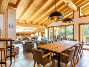 a dining room with a large wooden table and chairs at Apartment in France near Scenic Mountains in Abondance