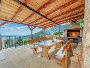 an outdoor patio with a table and a fireplace at Villa in Solin with Private Pool and Garden in Solin