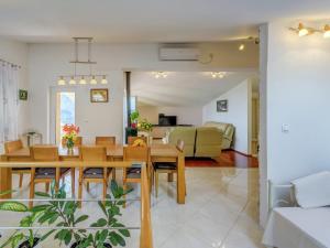 a dining room and living room with a table and chairs at Villa in Solin with Private Pool and Garden in Solin