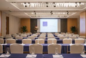 a conference room with chairs and a projection screen at Novotel Nanjing Central in Nanjing