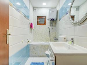 a bathroom with a sink and a tub and a toilet at Villa in Solin with Private Pool and Garden in Solin +32 photos
