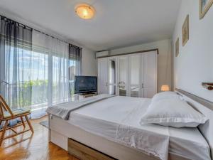 a bedroom with a large bed and a television at Villa in Solin with Private Pool and Garden in Solin
