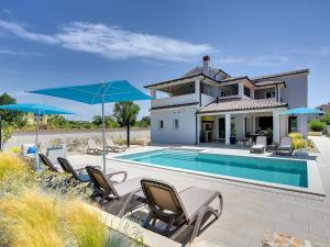 a villa with a swimming pool and patio furniture at Villa in Premantura with Pool near Beach in Premantura