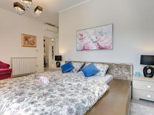 a bedroom with a bed with blue and pink pillows at Villa in Premantura with Pool near Beach in Premantura +29 photos
