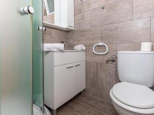 a small bathroom with a toilet and a shower at Holiday Home Dramalj with Pool near Sea in Dramalj +27 photos
