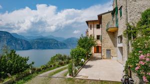 a view of a lake and a building at VIEW Garda Lake in Brenzone sul Garda